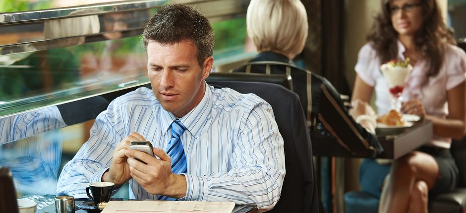 business-man-texting-at-lunch